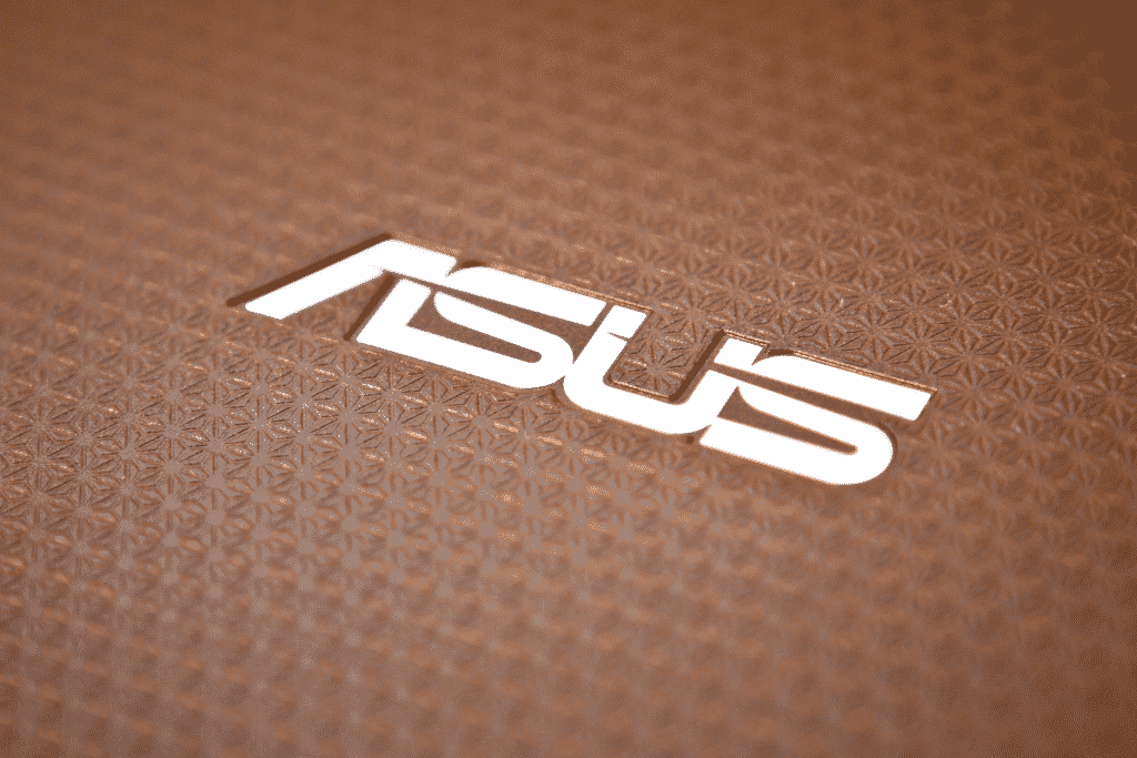 ASUS logo on textured surface, technology branding, modern design.