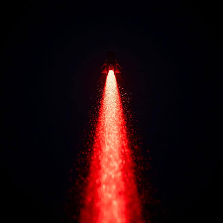 Red laser beam shooting into dark space, symbolizing cybersecurity threats.